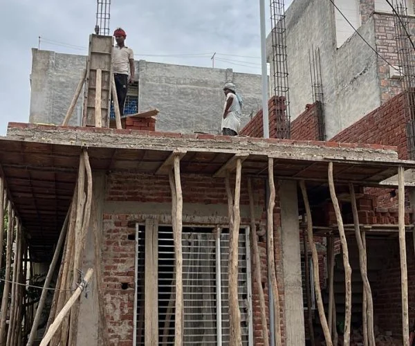 Residential construction site in kharar progressed by dream vision, the best architect in kharar, showing brick structure, scaffolding, and workers during the early stage of building a home.